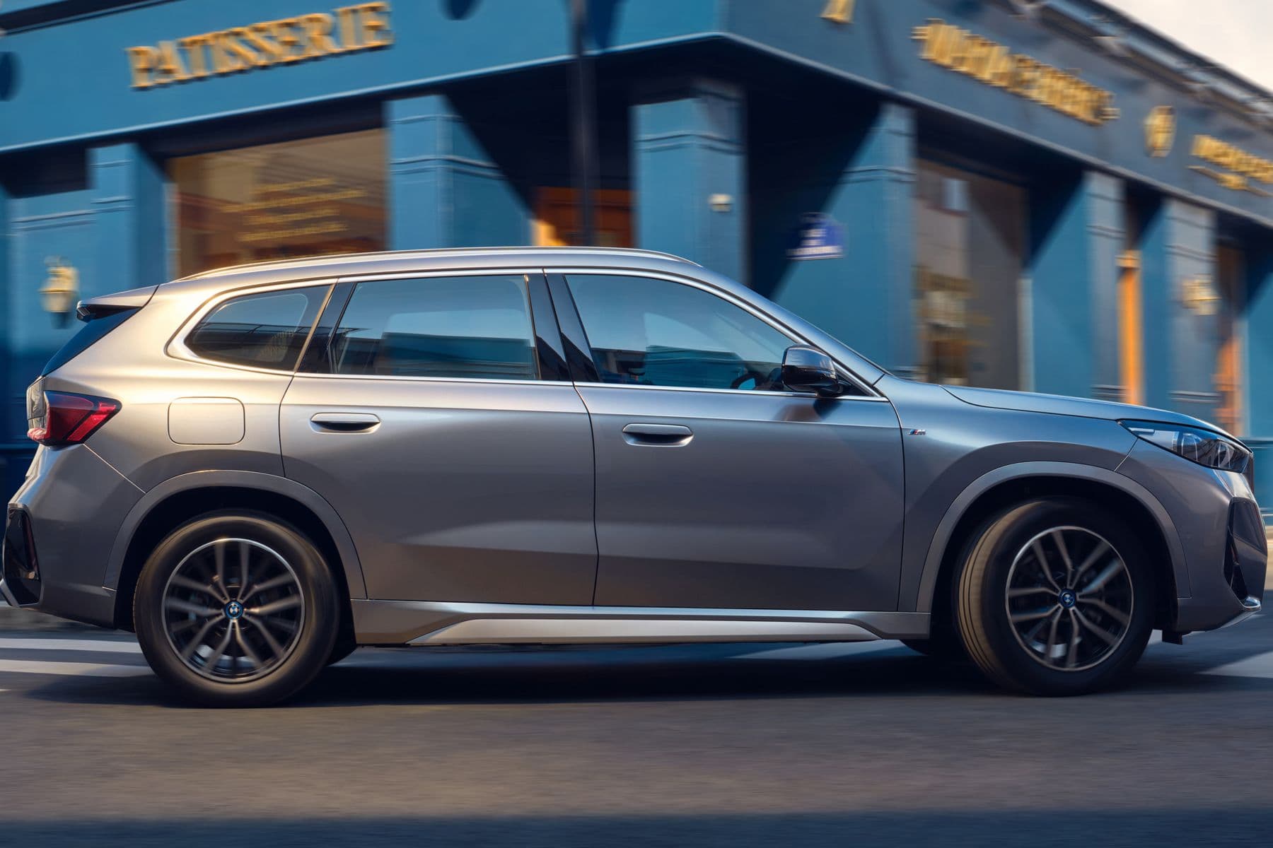 BMW iX1 Long Wheelbase xDrive30 electric compact SUV exterior, side view.